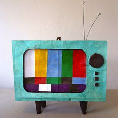 an old fashioned television sitting on top of a table