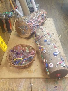 a wooden table topped with lots of assorted items on it's sides and a basket filled with beads