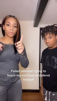 a woman giving the thumbs up while standing next to a young boy in front of a mirror