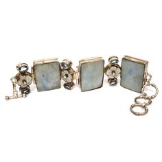 This is quite the statement piece!  Sterling silver holds 3 large rectangular slabs of blue gray mother of pearl or pale abalone.  Between the rectangles are bands with faceted blue topaz stones bezel set on either side of carved white mother of pearl flowers.  At the center of each flower is a raised bezel set cultured pearl.  Toggle clasp.  Bold and chunky!  Great style! Measurements:  approx 9-5/8" total length x 1-5/8" at the widest x 3/8" at the thickest (where the pearls top the MOP flowers).  The toggle clasp allows for a variable wearing lengths of 7-3/4", 8-3/4", and 9-3/8". Markings:  stamped with the maker's mark MD and the with the sterling number 925. Very good to near excellent condition.  There are minor typical irregularities in the shell. V270 Take a look at my shop ~ Indu Rectangular Silver Jewelry With Stones, Unique Blue Rectangular Jewelry, Artisan Blue Rectangular Jewelry, Rectangular Silver Jewelry With Natural Stones, Silver Rectangular Jewelry With Natural Stones, Pearl Flowers, Sterling Bracelets, Blue Topaz Stone, Maker's Mark