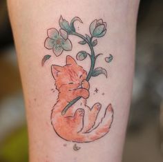 a tattoo on the leg of a woman with a fox and flowers in it's claws