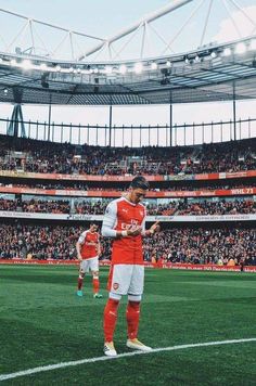 a man standing on top of a soccer field