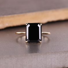 4.95 CT Emerald Cut Black Moissanite Engagement Ring, Hidden Halo Moissanite Ring, Handmade Ring, Anniversary Ring for Women, Claw Prong Ring, Anniversary Gift, Black Round Moissanite Hidden Halo Ring, Black Moissanite Engagement Ring, Mother's Day Sale 𝐖𝐚𝐫𝐫𝐚𝐧𝐭𝐲: 1. We offer a 𝟑𝟎-𝐝𝐚𝐲 warranty on all our jewelry. 2. We also provide paid service after the completion of the warranty. 3. You can send us an email or can send a message on Etsy 24x7 for any service required after that. 𝐈𝐭𝐞𝐦 𝐒𝐩𝐞𝐜𝐢𝐟𝐢𝐜𝐚𝐭𝐢𝐨𝐧: Center Stone Shape: Emerald Cut ◼Carat Weight: 4.95CT ◼Dimension: 11.15 X 9.06 X 5.65 MM ◼Color: Black ◼Cut Grade: Excellent Side Stone Shape: Round Cut ◼Carat Weight: 0.22 TCW ◼Dimension: 1.00 MM ◼Color: Black ◼Cut Grade: Excellent 𝐌𝐞𝐭𝐚𝐥 𝐝𝐞𝐭𝐚𝐢𝐥𝐬: 1. We Black Emerald Ring, Black Emerald Cut Engagement Ring, Emerald Cut Black Diamond Ring, Black Moissanite Engagement Ring, Unique Black Diamond Engagement Ring, Black Stone Ring Engagement, Moissanite Engagement Ring Hidden Halo, Engagement Ring Hidden Halo, Black Diamond Engagement Ring