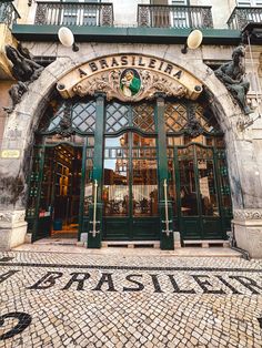 the entrance to an old building with green doors