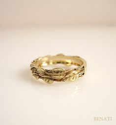 a close up of a gold ring on a white surface