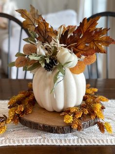 a white pumpkin sitting on top of a wooden table