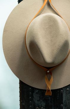 Keep your hat in pristine condition while making it an art piece. The Minerva Leather Hat Hanger is contemporary style in its simplest form. Raw materials, sleek design, outright excellence. • 100% Italian full-grain leather • Polished metal finishings • Hand cut and formed Made in Idaho, USA Hat Holders, Hat Hanger, Hat Holder, Leather Hat, Leather Hats, Natural Gold, Aging Well, Black Hardware, Brass Hardware