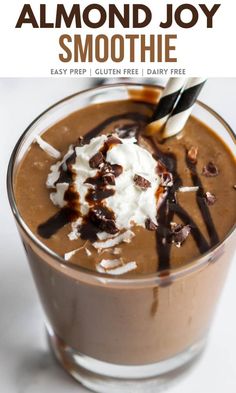 two glasses filled with chocolate milkshakes on top of a white tablecloth and striped straws