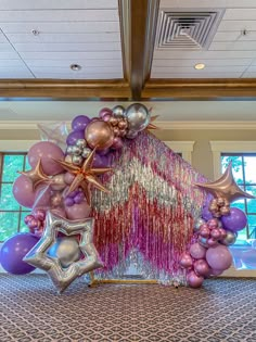 balloons and streamers decorate the entrance to a party