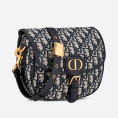 The Dior Bobby is a hobo style showcasing sophisticated lines and harmonious proportions. The model is crafted from Dior Oblique jacquard and enhanced by antique gold-finish metal hardware. Its removable and adjustable shoulder strap has a military-inspired buckle, and allows the medium bag to be carried on the shoulder or crossbody, as well as by hand. Flap design closure Magnetic clasp with decorative CD buckle Embossed 30 MONTAIGNE signature on the back Back pocket Interior patch pocket Adjustable and removable sliding leather shoulder strap Christian Dior military-inspired buckle Dust bag included Made in ItalyCOMPOSITIONDior Oblique JacquardProduct code:M9319UTZQ_M928SIZE GUIDE WIDTH×HEIGHT×DEPTH：22 x 17 x 6 cmLength from the top of the strap to the top of the bag:Minimum 42cm Maximum Medium Dior Bobby Bag, Dior Bobby Bag, Bobby Bag, Dior Oblique, Medium Bag, Hobo Style, Military Inspired, Magnetic Clasp, Medium Bags