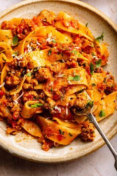 an easy italian sausage ragu with papparella sauce in a bowl on a table