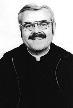 an old black and white photo of a man with glasses wearing a priest's outfit