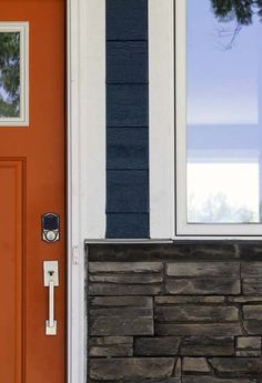 an orange front door with a black and white stripe on it