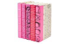 three books with pink covers and writing on the cover are lined up against each other