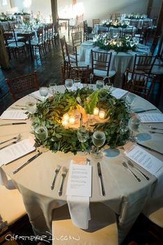 the table is set up with place settings for dinner and reception guests to enjoy it