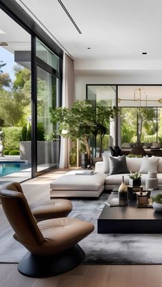 a living room filled with furniture and lots of windows next to a swimming pool in the background