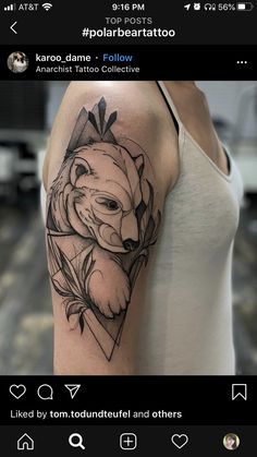 a woman's arm with a bear tattoo on it