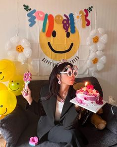 a woman sitting on a couch holding a cake