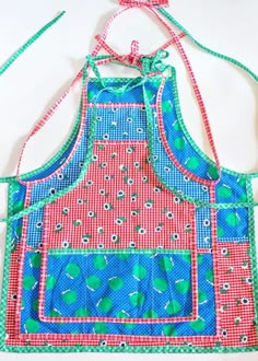 an apron made out of fabric with blue and red designs on it