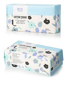 two boxes of cotton tissue sitting next to each other on a white surface with blue and green designs