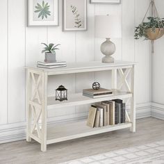 a white table with books and pictures on the wall