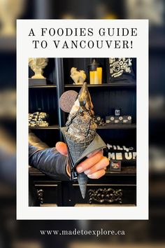 a person holding a piece of metal in their hand with the text, a foodies guide to vancouver