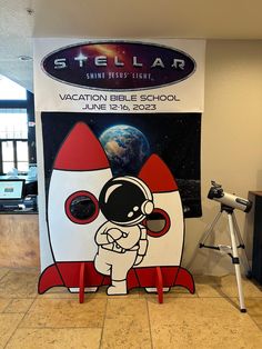 a sign with an astronaut on it in front of a space station poster board that says, vacation bible school june 12 - 19, 2013