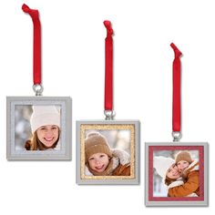 three christmas ornament hanging from red ribbon with two pictures on it and one has a smiling child