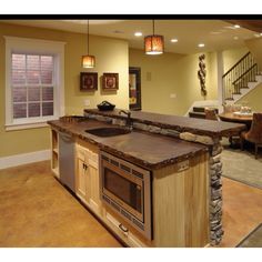 a kitchen with an island made out of wood and stone in the middle of it