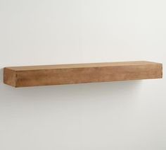 a wooden shelf mounted on the wall