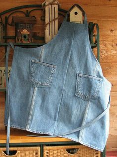 an apron made out of jeans hanging on a shelf