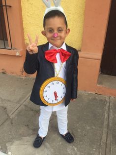 a little boy dressed up as a rabbit with a clock on his chest and nose