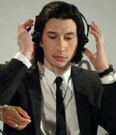 a man wearing headphones while sitting down