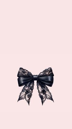 a black bow with lace on it is against a pink background and there is no image here to provide a caption for