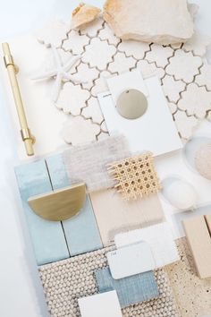 an assortment of different colors and materials on a white surface with a gold object in the middle