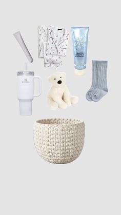 baby items are arranged in the shape of a basket, cup, and teddy bear