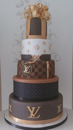 a three tiered cake is decorated with gold and brown designs on it's sides