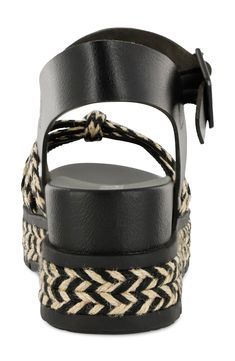 Two-tone braiding highlights the straps and platform sole of this earthy yet sophisticated sandal complete with a comfort-enhancing contoured footbed. 2 1/2" platform Adjustable ankle strap with buckle closure; hidden elastic inset Contoured footbed Textile and synthetic upper/synthetic lining and sole Imported Black Braided Sandals For The Beach, Straw Sandals With Braided Ankle Straps, Synthetic Sandals With Braided Ankle Straps, Black Braided Open Toe Sandals, Black Ankle Strap Sandals In Straw, Straw Wedge Sandals With Ankle Strap, Adjustable Buckle Closure Synthetic Wedge Sandals, Black Wedge Sandals With Adjustable Strap For Beach, Adjustable Platform Sandals In Synthetic Material