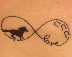 a tattoo with a horse and the word love written in cursive writing on it