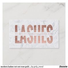 a marble business card with the words lashes printed in copper foil on top of it