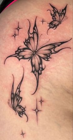 a woman's back with two butterflies on it