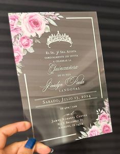 a person holding up a clear card with pink flowers on the front and back side