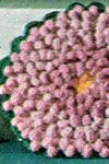 there is a crocheted flower on the table