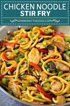 chicken noodle stir fry in a pan with green onions and peppers