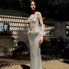 This dress made from a shimmering mint-green fabric. The dress features a sleeveless design with a subtle scoop neckline. The fabric appears to be slightly translucent and is embellished with intricate patterns, adding a touch of elegance and sparkle to the overall look. The dress contours the body closely, highlighting the figure and creating a sleek, sophisticated silhouette. This gown is ideal for formal events, evening wear, or special occasions where a touch of glamour is desired. %100 Poly Green Sleeveless Slip Dress For Wedding, Sleeveless Shimmer Cocktail Evening Dress, Sleeveless Shimmer Dress For Weddings, Sleeveless Shimmer Dresses For Wedding, Green Sleeveless Embellished Maxi Dress, Green Embellished Sleeveless Maxi Dress, Sleeveless Embellished Green Maxi Dress, Green Sleeveless Sequin Dress For Evening, Green Sleeveless Sequin Evening Dress