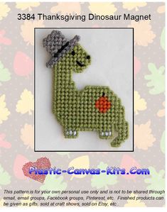 a green brooch with a hat on it's head and the words, 3504 thanksgiving dinosaur magnet