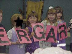 children holding up signs that say ergar