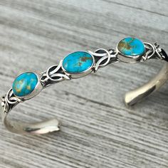 Kingman turquoise in sterling silver  Narrow but sturdy bracelet.   The silver band is about 1/4" wide and the turquoise stones are slightly wider than the band  This is made with half round silver material with the round side against your skin.  Just like a comfort band (ring) is made  The inside of the bracelet measures about 5 1/2" plus a 1" gap = 6 1/2" total wrist size.  This can be opened up a bit more to about a 7" total wrist size  Handmade by Navajo artist, Thomas Yazzie  signed and mar Bohemian Turquoise Sterling Silver Cuff Bracelet, Cloth Tape, Sterling Bracelets, Turquoise Stones, Kingman Turquoise, Silver Material, Tape Measure, Bracelet Sizes, Turquoise Stone