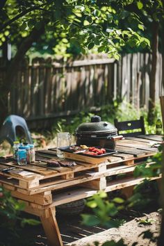 a picnic table with food on it in the backyard