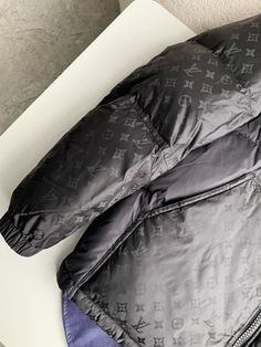 Embrace iconic luxury with this Monogram Puffer Jacket, channeling the essence of Louis Vuitton's timeless style. The all-over monogram print on a sleek black backdrop creates a bold yet sophisticated statement. Crafted with meticulous attention to detail and premium materials, this jacket offers warmth and unparalleled style. The hooded design and cozy fill ensure comfort during colder days, while the signature pattern adds a touch of high-fashion to your everyday look. Luxury Winter Outerwear With Monogram Print, Luxury Monogram Print Winter Outerwear, Luxury Monogram Print Outerwear For Winter, Luxury Monogram Printed Outerwear For Winter, Winter Black Outerwear With Logo Print, Luxury Monogram Print Fall Outerwear, Designer Winter Outerwear With Logo Print, Designer Black Winter Outerwear, Designer Logo Print Winter Outerwear